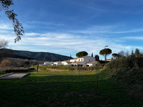 a group of white houses in a grassy field at La Maison d AME - for the perfect stay at the Mont Ventoux in Malaucène