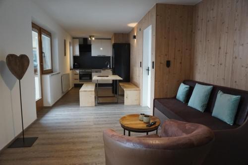 a living room with a couch and a table at Apart&Chalet Chiara in Neustift im Stubaital