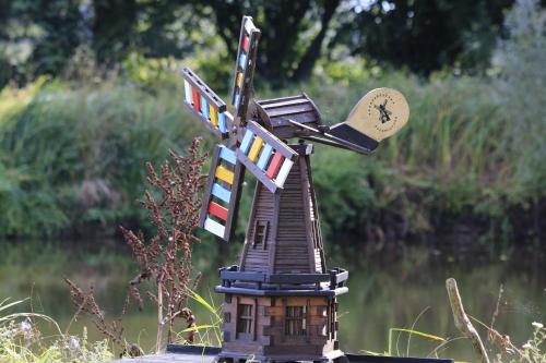 a small model of a house with a clock on it at Agroturystyka Żuławiaczek in Nowy Dwór Gdański