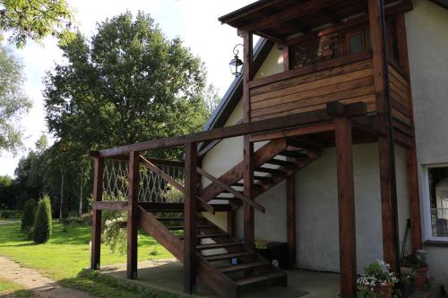 a wooden staircase leading up to a house at Agroturystyka Żuławiaczek in Nowy Dwór Gdański