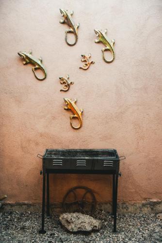 a wall with lizard hooks on a wall at Hostal Tulvak Atacama in San Pedro de Atacama