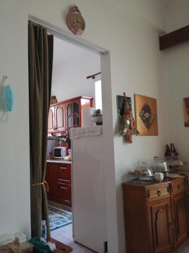an open door to a kitchen with a refrigerator at Hotel Fotini in Kamena Vourla