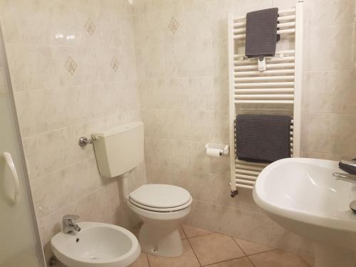 a bathroom with a white toilet and a sink at Apartment Le Logge in Sestriere