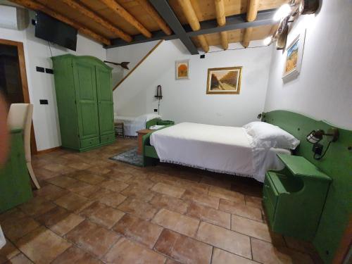 a bedroom with a white bed and green doors at BB IL CIPPO in Verona