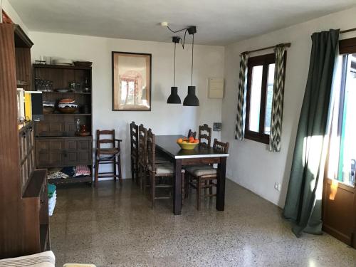 a kitchen and dining room with a table and chairs at Mountain Finca with Pool in Puigpunyent
