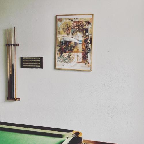 a picture hanging on a wall next to a table at Hotel Regina Terme in Leukerbad