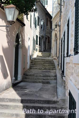 an alley with stairs in an old building at Fortezza Apartment in Herceg-Novi