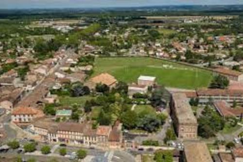 an overhead view of a city with a field and buildings at L'Oustal in Montech