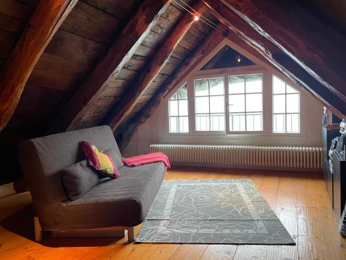 a living room with a couch in a attic at Casa indipendente con camino e mansarda. in Re