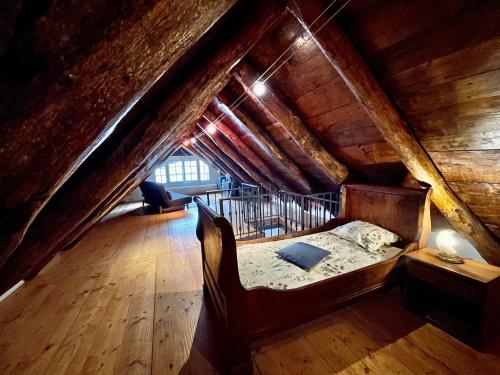 a bedroom with a bed in a attic at Casa indipendente con camino e mansarda. in Re