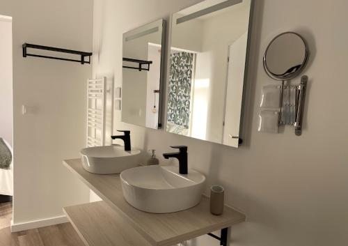 a bathroom with two sinks and a mirror at Quinta da Pedrulha in Valhelhas