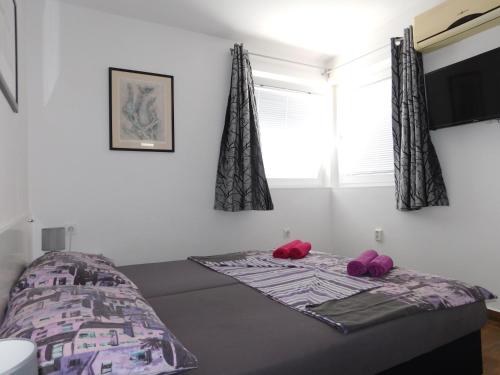 En eller flere senge i et værelse på Apartmani Tognon