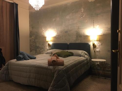 a bedroom with a bed with two towels on it at La Didì Maison in Bologna
