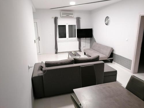 a living room with a couch and a table at Kilkis Paradise in Kilkís