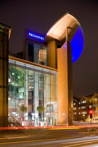 a building with a blue sign on top of it at Novotel Cardiff Centre in Cardiff