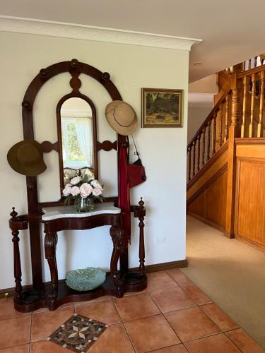 a room with a mirror and a table with flowers at Luxury 4 bedroom house in Deewhy