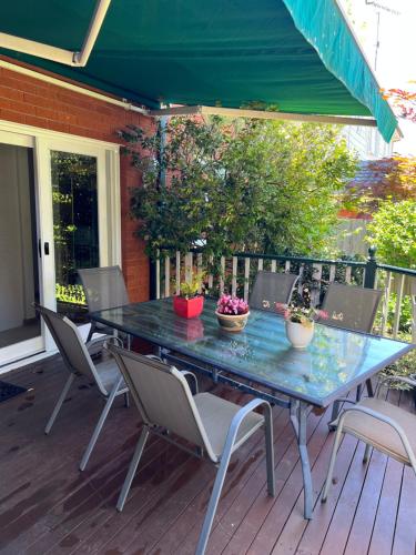 a blue table with chairs on a deck at Luxury 4 bedroom house in Deewhy