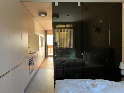 a bedroom with a bed with a mirror on the wall at SMART Apartments Mellau in Mellau