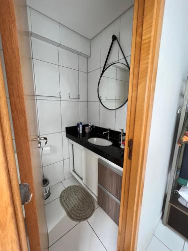 a bathroom with a sink and a mirror at Vale Hospedar Orla Apart in Petrolina