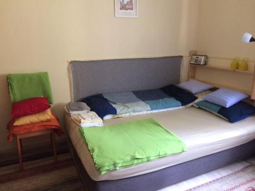 a bed with colorful sheets on it in a room at Casa Mamma in Budapest
