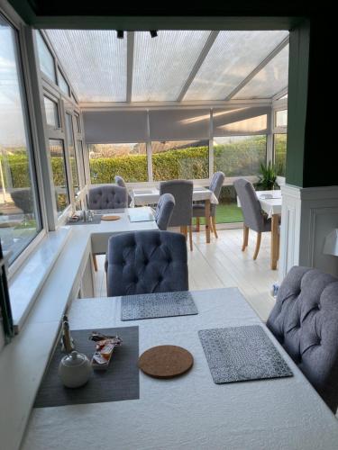 a living room with a table and chairs and a dining room at Overdale Motel in Lisburn