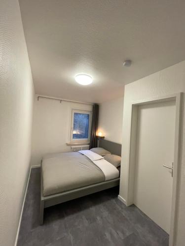 a small bedroom with a bed and a window at Breeman im Harz in Sankt Andreasberg