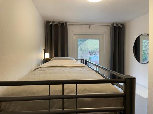 a bedroom with a bed and a window at Breeman im Harz in Sankt Andreasberg