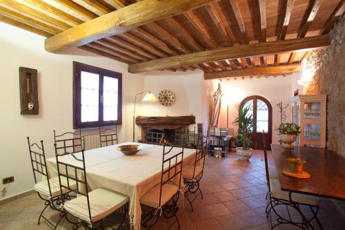 una cucina e una sala da pranzo con tavolo e sedie di Agriturismo Podere Santa Rita a Montescudaio