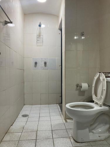 a bathroom with a toilet with the lid up at La Casa de los Abuelos in Tequila