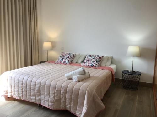 a bedroom with a large bed with two pillows at Calheta Ocean View Apartments 1 in Estreito da Calheta
