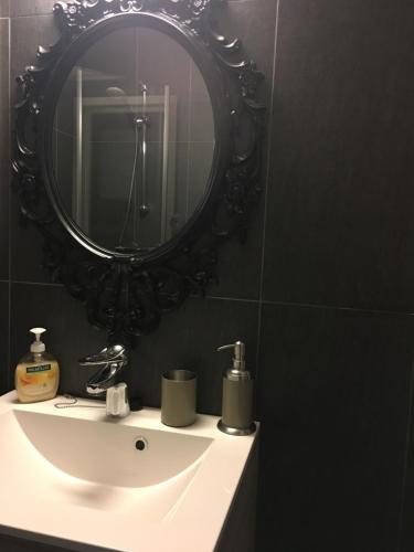 a bathroom with a white sink and a mirror at Voss- Oppheim suite private cozy cabin in Vossestrand
