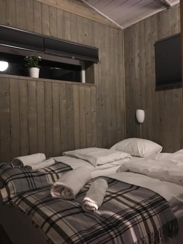a bedroom with a bed with towels on it at Voss- Oppheim suite private cozy cabin in Vossestrand