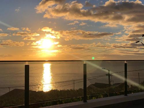 a view of the sun setting over the ocean at Calheta Ocean View Apartments 1 - Air Condition in Estreito da Calheta