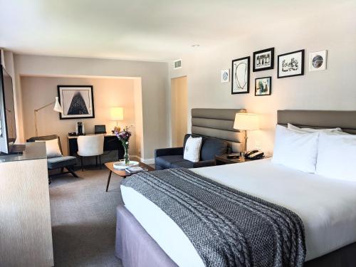 a hotel room with a bed and a living room at Claridge House in Chicago