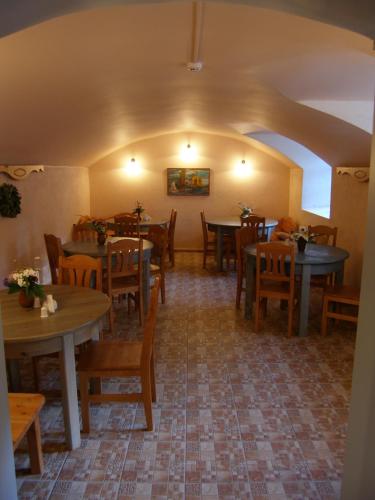 a restaurant with tables and chairs in a room at Viesu māja Sprīdīši in Tērvete
