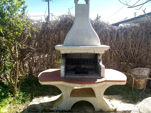 an outdoor fireplace in the middle of a yard at Modern 1-bedroom with BBQ & Roof Garden near Beach in Stalos