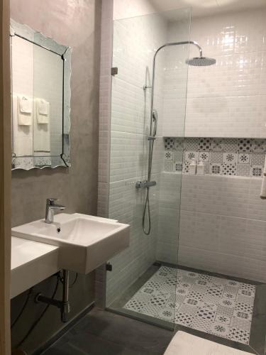a bathroom with a sink and a shower at Yellow door Hua Hin in Hua Hin