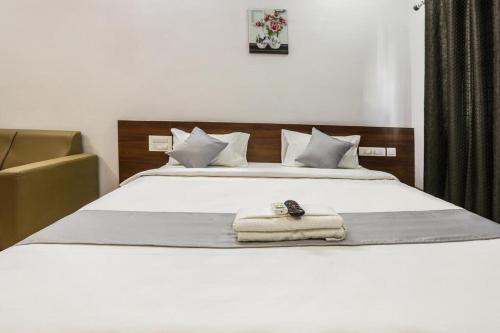 a bedroom with a bed with a towel on it at Hotel Gateway Suites Bangalore Airport in Yelahanka