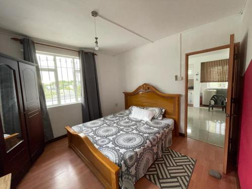 a bedroom with a bed in a room at Green Bay Villa in Pereybere