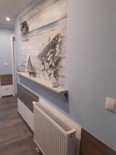 a wall with a painting of a ship at JaNettes Gästehaus in Bad Doberan