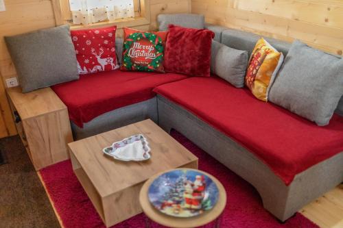 a living room with a couch and a table at Green Top with jacuzzi in Žabljak