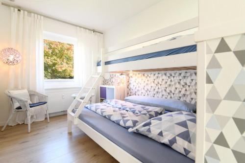a bedroom with a bunk bed with a ladder at Exklusives Ferienhaus mit Schwimmbad und Sauna in Grömitz