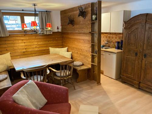 a kitchen with a wooden table and a dining room at Appartementhaus Grocke in Wagrain