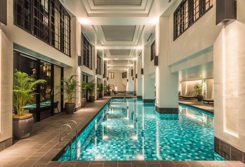a swimming pool in a building with a hotel at Hotel Monterey Okinawa Spa & Resort in Onna