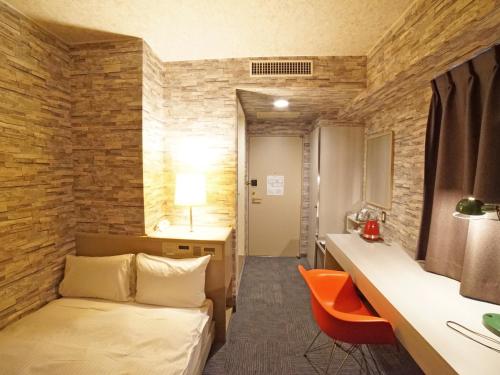 a hotel room with a bed and a desk at Hotel AreaOne Takamatsu City in Takamatsu