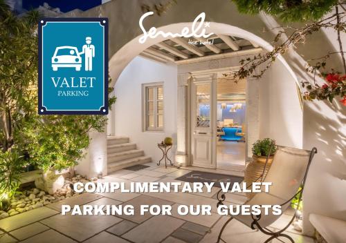 a property with a sign that readsvalet rental parking for our guests at Semeli Hotel Mykonos in Mýkonos City
