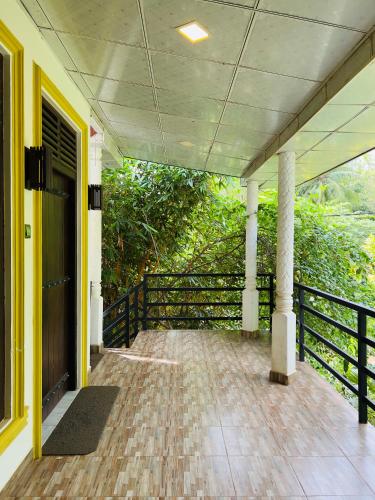 an empty porch of a house with a fence at Yala Southern Homestay in Tissamaharama