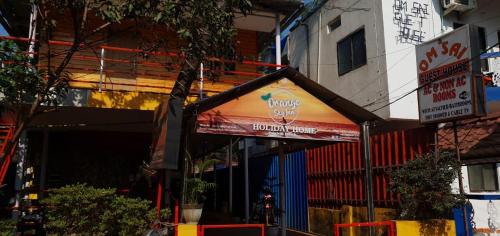 a building with a drink sign on the side of it at ORANGE SKY INN HOLIDAY HOME in Canacona