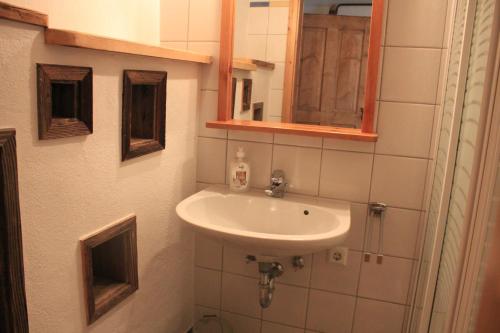 a bathroom with a sink and a mirror at Urlaub am Bio-Bauernhof Liebchen in Zeutschach