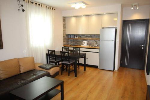 a living room with a couch and a table and a kitchen at Royal Apartments , Blvd Nitza 8 in Netanya